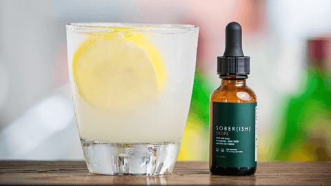 Image of mocktail drink with lemon and Sober(ish) THC Drops