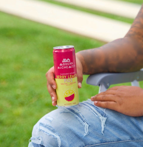 Person holding Berry Lemon Fizz Modern Alchemist Cannabis Infused Mocktail. Alcohol free.