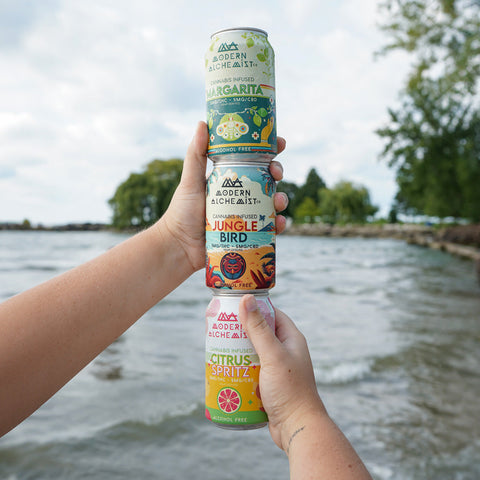 Cans stacked on top of each other including Modern Alchemist Jungle Bird Cannabis Infused Mocktail. Alcohol free.