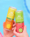 Cans of Cherry Lime Fizz Modern Alchemist Cannabis Infused Mocktail & Mango Yuzu Fizz by the pool. Alcohol free. 