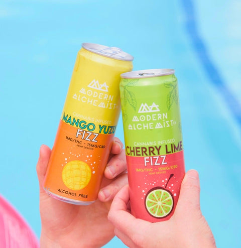 Cans of Cherry Lime Fizz Modern Alchemist Cannabis Infused Mocktail & Mango Yuzu Fizz by the pool. Alcohol free. 