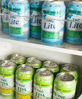 Cans of Float House THC Lite and THC IPA in a refrigerator.