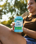 Person holding a can of 'THC Lite' with a natural background