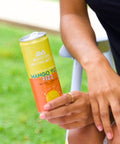 Person holding Mango Yuzu Fizz Modern Alchemist Cannabis Infused Mocktail. Alcohol free.