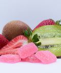 Fruit gummies and strawberries on a white background