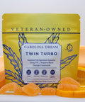 Yellow package labeled 'Carolina Dream Twin Turbo' with orange gummies and popsicle on a white background