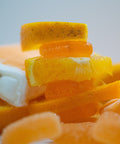 Close-up of sliced oranges and other citrus fruits on a white background