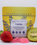 Yellow package labeled 'Carolina Dream Turbo' with a strawberry, kiwi, and gummies on a white background.