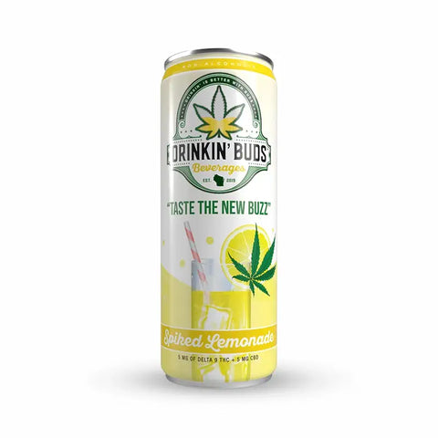 The image features a single can of "Drinkin' Buds Beverages" in Spiked Lemonade flavor, with a clean white and yellow label. The design includes a cannabis leaf, the slogan "Taste the New Buzz," and a depiction of a lemonade glass with a straw, highlighting the drink's citrus and refreshing profile infused with 5 mg of Delta 9 THC and 5 mg of CBD.