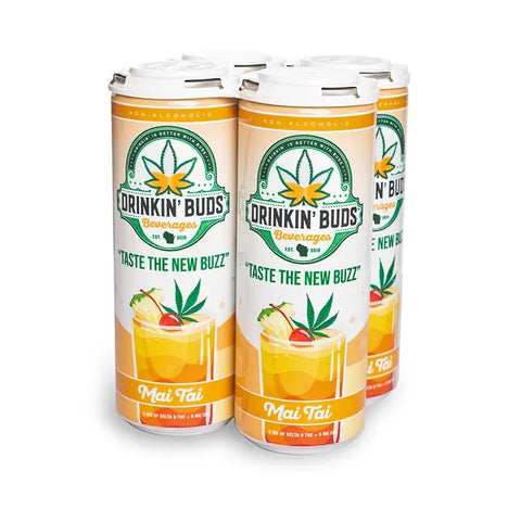 The image features a four-pack of "Drinkin' Buds Beverages" in Mai Tai flavor. The cans are decorated with tropical imagery, including a cannabis leaf, the slogan "Taste the New Buzz," and a Mai Tai cocktail illustration, emphasizing a fruity, infused experience.