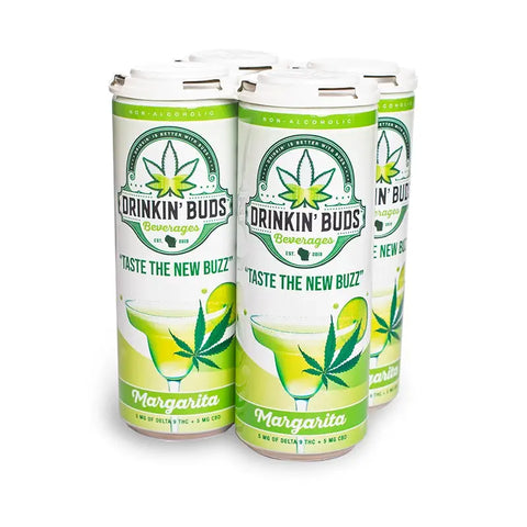 The image shows a four-pack of "Drinkin' Buds Beverages" in Margarita flavor, with a white and green design. The cans display a cannabis leaf logo, the slogan "Taste the New Buzz," and an illustration of a margarita glass with a lime wedge, emphasizing the drink's refreshing, citrusy profile infused with 5 mg of Delta 9 THC and 5 mg of CBD.