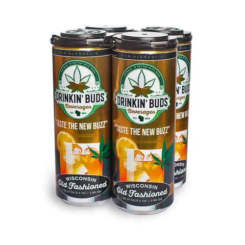 The image depicts a four-pack of "Drinkin' Buds Beverages" in the Wisconsin Old Fashioned flavor, presented in tall, sleek cans. The label showcases a cannabis leaf and the slogan "Taste the New Buzz," along with a graphic of an Old Fashioned cocktail garnished with an orange slice and cherry.