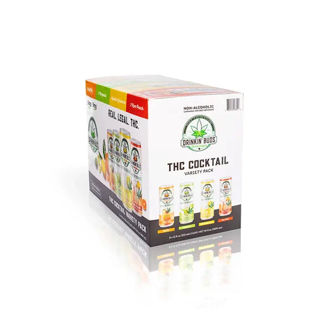 The image shows a boxed "Drinkin' Buds Beverages" THC Cocktail Variety Pack, labeled as non-alcoholic and cannabis-infused. The packaging features the slogan "Real. Legal. THC." and displays all four flavors: Margarita, Spiked Lemonade, Mai Tai, and Rum Punch.