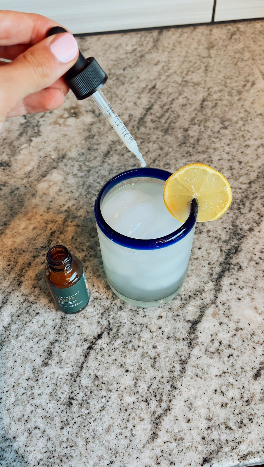 Adding Sober(ish) Drops to a glass of lemonade