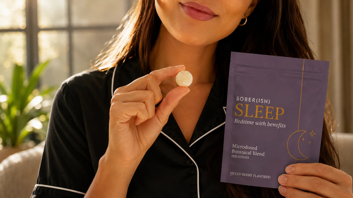 Woman in pajamas holding a Sober(ish) Sleep gummy and pouch